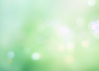 Green blurred bokeh background, abstract lights, spring foliage.