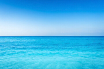 Obraz premium Calm turquoise ocean under a clear blue sky; perfect for travel or summer brochures