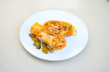 Lavash doner kebab ( zurna doner durum )  or shawarma sliced in plate isolated.  Tavuk Et Doner Durum. Hatay usulu tavuk doner durum. 