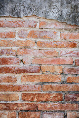 A close-up of a weathered brick wall with visible mortar and subtle variations in brick color and texture. The image conveys a sense of age, history, and rustic charm.