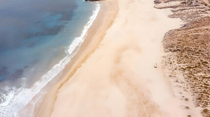 Aerial beach view with gentle waves hitting the shore, showcasing tranquility; perfect for travel brochures and vacation planning