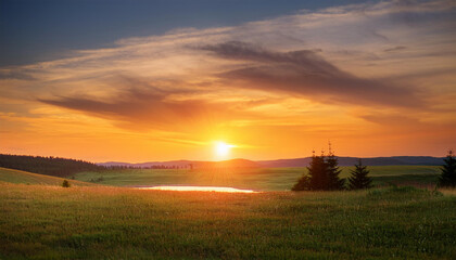 Fototapeta premium warm orange hues descend upon the landscape at dusk natural scenery warm glow calm evening