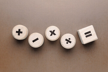 Mathematics operation symbol on the wood toy, plus minus multiply divide, and equal sign