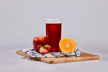 Strawberry, apple, orange mix with soft drink decorate with surrounding fruit.