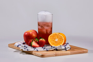 Strawberry, apple, orange mix with soft drink decorate with surrounding fruit.