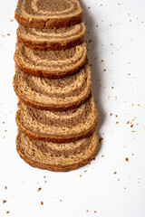 Slice ​​piece dark light bread dough twisted spiral white background coarse grinding