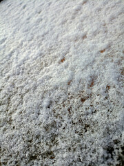Snow cover, crystalline snow texture, white background - color vertical photo, close-up