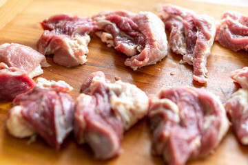 Pieces of raw meat on a wooden board. Food concept