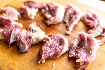 Pieces of raw meat on a wooden board. Food concept