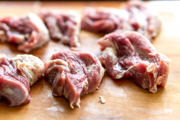 Pieces of raw meat on a wooden board. Food concept
