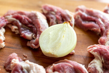 Pieces of raw meat on a wooden board. Food concept