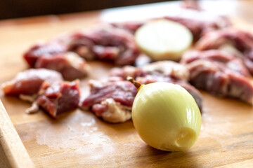 Pieces of raw meat on a wooden board. Food concept