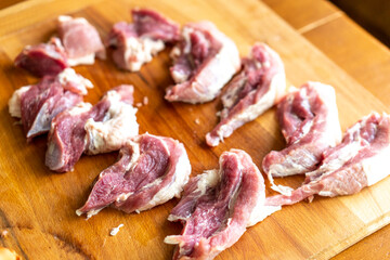 Pieces of raw meat on a wooden board. Food concept