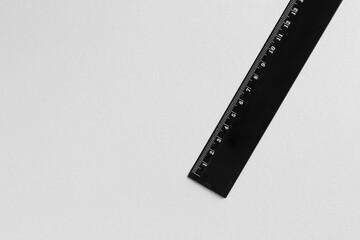 One black ruler on light grey background, top view. Space for text
