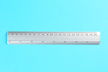 One metal ruler on light blue background, top view