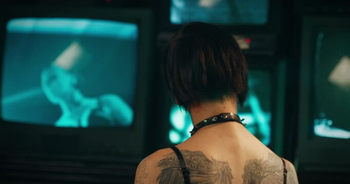 Aggressive young woman with tattoos and piercings looking at camera, portrait. Subculture of gothic and rock, alternative style, alt woman, self-expression by appearance, deviant behavior of youth