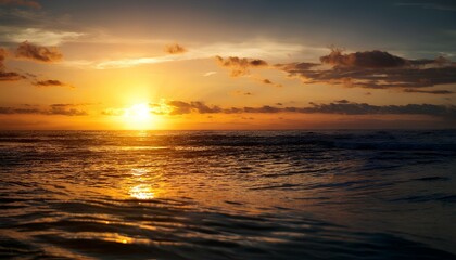 Fototapeta premium the golden hues of a sunset reflecting on a perfectly calm ocean