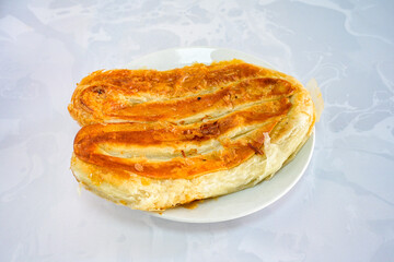 Turkish style meat stuffed filo dough borek served kol boregi. Cheese and minced pie are sliced on...
