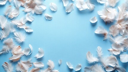 Numerous fluffy white feathers are scattered on the left side of a pastel sky blue background in this top view photo with copyspace.