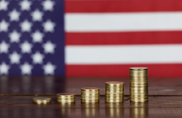 Growing gold coins with american flag in the background. Business success, USA investments.
