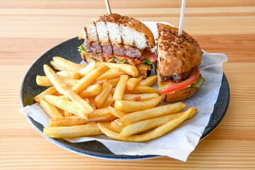 Big tasty burger with beef cutlet on a plate. Hamburger, cheeseburger with mushroom. Hamburger, Mexica, mushroom double burger.  Crispy chicken burger. With french fries, patates kizartmasi.