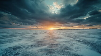 Obraz premium Winter storms blizzard landscape concept, Expansive view of the ocean at sunset, with dramatic clouds reflecting warm colors.