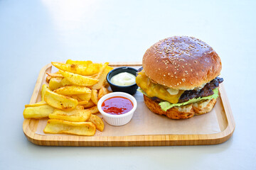 Big tasty burger with beef cutlet on a plate. Hamburger, cheeseburger with mushroom. Hamburger, Mexica, mushroom double burger.  Crispy chicken burger. With french fries, patates kizartmasi.