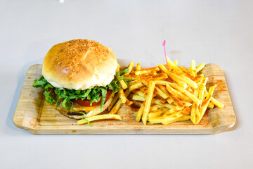 Big tasty burger with beef cutlet on a plate. Hamburger, cheeseburger with mushroom. Hamburger, Mexica, mushroom double burger.  Crispy chicken burger. With french fries, patates kizartmasi.