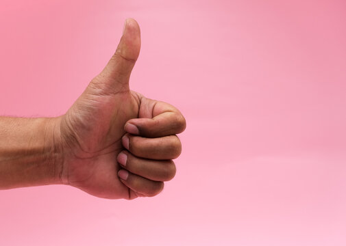 Photo of person showing thumb up sign approval isolated pink background