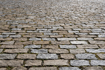 Cobblestone street with gray and beige paving stones - surface level