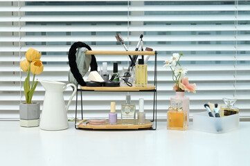 Various cosmetics and objects on a vanity table for a woman to do her makeup	
