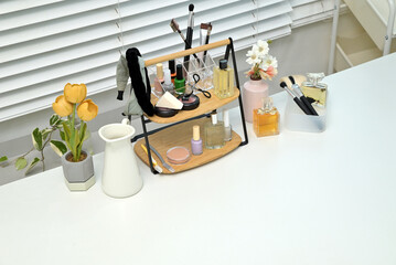 Various cosmetics and objects on a vanity table for a woman to do her makeup	
