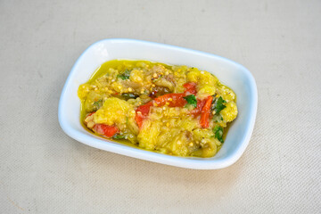 Grilled eggplant paste appetizer on white background .Healthy food. Turkish name koz patlican ezmesi. Koz patlican, koz kirmizi biber kapya salatasi.