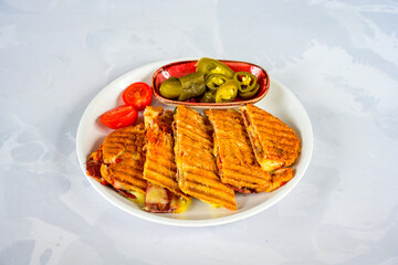 Turkish karisik atom Ayvalik tost ( kasarli bazlama tost) . Sucuklu, Kasarli, kavurmali karisik tost. Flat baked bread toasted. Karisik bazlama tost .  