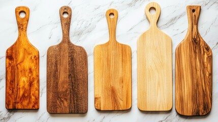 Perfectly clean and organized wooden chopping boards on a marble countertop.