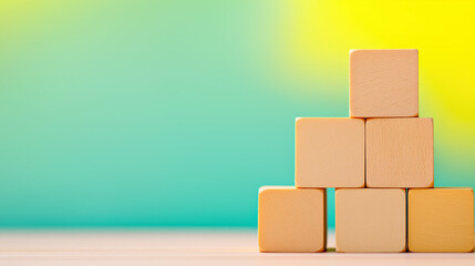 Obraz premium Stacking Wooden Blocks In A Steady Tower, Symbolizing Building A Strong Foundation For Future Stability, With Copy Space For Text.