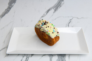 Freshly baked Croissant on the table. Croissant. croissant in white plate on white background. (Tr - kruvasan, Fr - croissant). Beyaz cikolatali kruvasan, bella kruvasan.