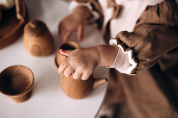 hand holding a wooden teapot