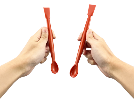 Hands holding red plastic laboratory spatulas with spoon and flat ends, designed for precise powder and chemical handling. Ideal for scientific, medical, research, and industrial use.