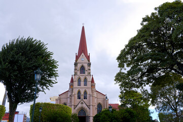 landmark church framed by trees and park greenery in downtown san jose costa rica