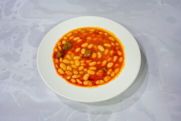 Turkish Etli Kuru Fasulye food with Traditional Turkish table with decoration. Nohut yemegi. Pilav ustu, kuru fasulye, nohut. Gunun menusu.