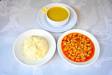 Turkish Etli Kuru Fasulye food with Traditional Turkish table with decoration. Nohut yemegi. Pilav ustu, kuru fasulye, nohut. Gunun menusu.
