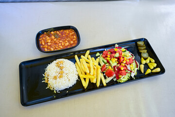 Turkish Etli Kuru Fasulye food with Traditional Turkish table with decoration. Nohut yemegi. Pilav ustu, kuru fasulye, nohut. Gunun menusu.