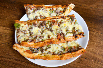 Kiymali pide.Turkish pide with minced meat. Turkish pizza mince pita Pide on white . Etli ekmek.Kusbasi kasarli, kiymali kasarli, kiymali yumurtali, Bafra, Trabzon, Kusbasili pide. Urfa acili lahmacun