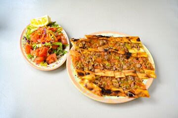 Kiymali pide.Turkish pide with minced meat. Turkish pizza mince pita Pide on white . Etli ekmek.Kusbasi kasarli, kiymali kasarli, kiymali yumurtali, Bafra, Trabzon, Kusbasili pide. Urfa acili lahmacun
