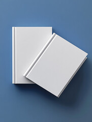 Two white book mockups, top view, on a blue background