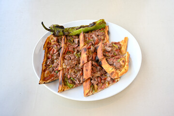 Kiymali pide.Turkish pide with minced meat. Turkish pizza mince pita Pide on white . Etli ekmek.Kusbasi kasarli, kiymali kasarli, kiymali yumurtali, Bafra, Trabzon, Kusbasili pide. Urfa acili lahmacun