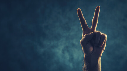 Hand making peace sign against dark background, symbolizing harmony and positivity. gesture conveys message of hope and unity