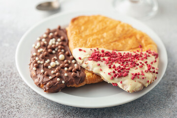 Flat Croissants, Trendy Pastry, Croissant with chocolate icing and pastry sprinkles