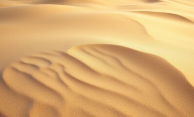 Waves of golden sand in desert landscape